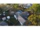 An aerial view of a home with a screened-in pool and spacious backyard at 2233 Egret Walk Ct, New Port Richey, FL 34655