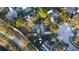An overhead view of a home with a screened pool, backyard shed, and nearby trees at 2233 Egret Walk Ct, New Port Richey, FL 34655