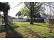 Spacious backyard with mature trees and lush greenery, ideal for outdoor activities at 2233 Egret Walk Ct, New Port Richey, FL 34655
