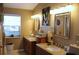 Bright bathroom features double vanity sinks, light fixtures and decorative mirrors at 2233 Egret Walk Ct, New Port Richey, FL 34655