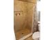 Well-lit bathroom featuring tiled walls, stone flooring, and a built-in shower niche at 2233 Egret Walk Ct, New Port Richey, FL 34655