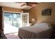 Cozy bedroom features a sliding glass door that opens onto a screened patio at 2233 Egret Walk Ct, New Port Richey, FL 34655