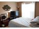 Cozy bedroom with a large window, TV, and calming decor, perfect for relaxation at 2233 Egret Walk Ct, New Port Richey, FL 34655