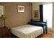 Simple bedroom with a single bed, wooden dresser, and artwork on the walls at 2233 Egret Walk Ct, New Port Richey, FL 34655