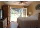 Bright bedroom features sliding french doors and a view of the pool at 2233 Egret Walk Ct, New Port Richey, FL 34655