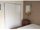 Bedroom featuring a mirrored closet, wooden dresser, and neutral decor for a peaceful setting at 2233 Egret Walk Ct, New Port Richey, FL 34655