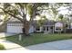 Charming single-story home with a well-maintained lawn and mature landscaping at 2233 Egret Walk Ct, New Port Richey, FL 34655