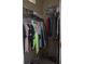 Walk-in closet features ample storage with shelves, rods and multiple rows of clothes at 2233 Egret Walk Ct, New Port Richey, FL 34655