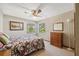 Bedroom featuring dual windows, a ceiling fan, and a chest of drawers at 2454 Landover Blvd, Spring Hill, FL 34608