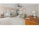 Bright and airy living room with neutral tones, ceiling fan, and ample seating area at 2454 Landover Blvd, Spring Hill, FL 34608