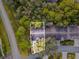 Aerial view of the property showcasing the location and proximity to surrounding trees at 3216 Appleblossom Trl, Spring Hill, FL 34606