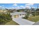 Aerial view of home showcasing the roof, driveway, and waterfront location in a residential neighborhood at 3449 Companero Entra, Hernando Beach, FL 34607