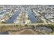 Expansive aerial view of a waterfront community featuring canals and well-maintained homes in a desirable neighborhood at 3449 Companero Entra, Hernando Beach, FL 34607