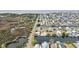 Aerial perspective of a home, dock, and canal in a residential neighborhood near open wetlands and water at 3449 Companero Entra, Hernando Beach, FL 34607