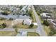 A single-story home is shown from an aerial view featuring a private boat dock on a canal and a large drive at 3449 Companero Entra, Hernando Beach, FL 34607