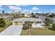 Charming single-story home featuring a long driveway, well-maintained lawn, and waterfront views at 3449 Companero Entra, Hernando Beach, FL 34607