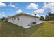 The corner of a single-story stucco home with gray trim and grass at 3449 Companero Entra, Hernando Beach, FL 34607