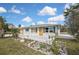 The front exterior of a single-story home has a large front porch and a rock garden at 3449 Companero Entra, Hernando Beach, FL 34607