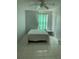Bedroom featuring tile floors, a ceiling fan, and a window with a colorful curtain at 3801 Kimball Ave, Tampa, FL 33614