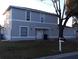 Two-story home featuring a gray exterior, white trim, front yard, and a mailbox at 3801 Kimball Ave, Tampa, FL 33614