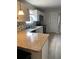 Well-lit kitchen featuring granite countertops, stainless steel appliances, and white cabinets at 3801 Kimball Ave, Tampa, FL 33614