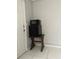 Kitchenette area with a mini-fridge and microwave, complemented by tiled flooring and neutral wall colors at 3801 Kimball Ave, Tampa, FL 33614