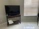 Living room featuring a TV, tile floors, and a window with blinds at 3801 Kimball Ave, Tampa, FL 33614