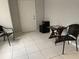 Room with light gray walls and a tile floor, staged with a table and chairs at 3801 Kimball Ave, Tampa, FL 33614