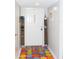 Bright entryway with gray walls, a colorful rug, and white front door at 3850 Staysail Ln, Holiday, FL 34691