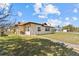 Charming single-story home featuring a well-maintained lawn under a partly cloudy sky at 4488 Bimini Dr, Hernando Beach, FL 34607