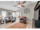 Bright living room featuring wood floors, vaulted ceilings, a ceiling fan, and comfortable seating at 4655 Wallingford Ct, New Port Richey, FL 34655