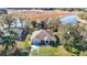 Stunning aerial view of a home near a peaceful lake, surrounded by lush greenery and natural beauty at 469 Fairbanks Rd, Spring Hill, FL 34608