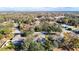 Aerial view of a property with a pool in a lush, wooded neighborhood with mature trees at 469 Fairbanks Rd, Spring Hill, FL 34608