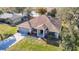 Scenic aerial shot of a one-story home with lush landscaping, a two-car garage, and serene surroundings at 469 Fairbanks Rd, Spring Hill, FL 34608