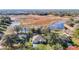 Breathtaking aerial view of a home near a tranquil lake, surrounded by natural wetlands and verdant greenery at 469 Fairbanks Rd, Spring Hill, FL 34608