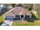 Charming aerial view of a one-story home with a two-car garage, manicured lawn, and inviting curb appeal at 469 Fairbanks Rd, Spring Hill, FL 34608