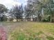 A spacious and well-maintained backyard with view of trees in distance at 469 Fairbanks Rd, Spring Hill, FL 34608
