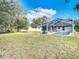 Expansive backyard featuring a pool and screened enclosure at 469 Fairbanks Rd, Spring Hill, FL 34608
