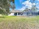 A lush backyard featuring an in-ground pool and screened enclosure at 469 Fairbanks Rd, Spring Hill, FL 34608