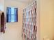 Close-up of a bathroom with a decorative shower curtain and natural light at 469 Fairbanks Rd, Spring Hill, FL 34608