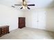 Spacious bedroom featuring a ceiling fan, double door closet and wooden dressers for storage at 469 Fairbanks Rd, Spring Hill, FL 34608