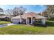 Well-kept one-story home with a two-car garage, lush lawn, and an attractive facade at 469 Fairbanks Rd, Spring Hill, FL 34608