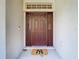 Inviting front entryway featuring a decorative door with sidelights and a stylish welcome mat at 469 Fairbanks Rd, Spring Hill, FL 34608