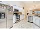 Bright kitchen features stainless steel appliances and neutral tile flooring at 469 Fairbanks Rd, Spring Hill, FL 34608