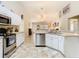 Well-lit kitchen with stainless steel appliances and open access to living area at 469 Fairbanks Rd, Spring Hill, FL 34608