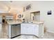 Kitchen sink area features stainless steel dishwasher and a view of living area at 469 Fairbanks Rd, Spring Hill, FL 34608