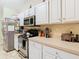 Kitchen featuring stainless steel appliances, white cabinets, and ample counter space at 469 Fairbanks Rd, Spring Hill, FL 34608