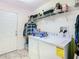 Laundry room featuring a white washer and dryer with overhead shelving at 469 Fairbanks Rd, Spring Hill, FL 34608