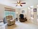 Open living room with large windows, ceiling fan, and views into the entry and dining areas at 469 Fairbanks Rd, Spring Hill, FL 34608