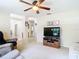 Inviting living room with neutral carpet and walls, ceiling fan, and ample natural light at 469 Fairbanks Rd, Spring Hill, FL 34608